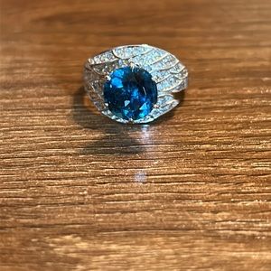 Sterling silver ring with peacock blue gemstone and clear stones.  Size 9.5